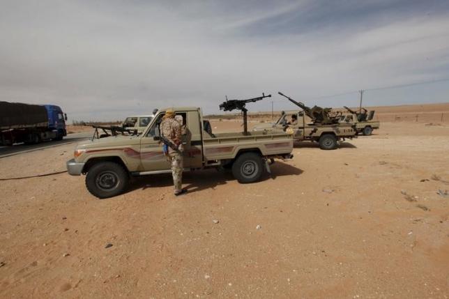 Libyan military vehicles are pictured at a checkpoint in Wadi Bey, west of the Islamic State-held city of Sirte, February 23, 2016. REUTERS/Ismail Zitouny
