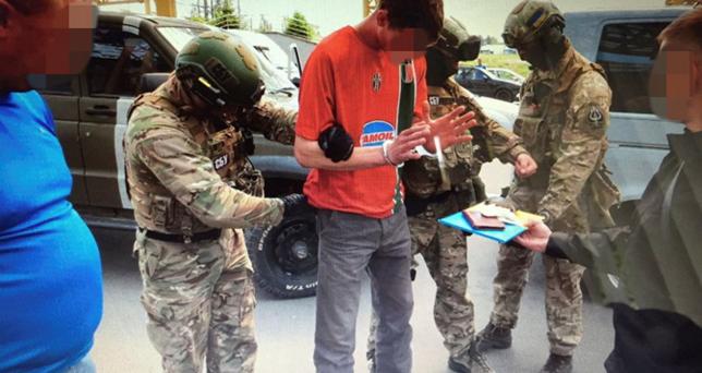 Members of Ukraine's state security service detain a French citizen who had been planning attacks in France to coincide with the Euro 2016 football championship it is hosting, on the Ukrainian-Polish border in Volyn region, Ukraine, in this undated photo released by Ukraine's state security service on June 6, 2016. Picture pixellated at source.       Ukraine's State Security Service/Handout via REUTERS